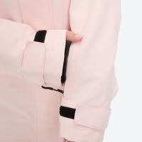 
                  
                    Women's waterproof 2L ski jacket and pants set - light pink, cuff close-up with hand, for resort and cross-country days
                  
                