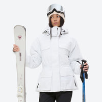 
                  
                    Women's 3-layer breathable ski suit - white, front with upright skis and poles, for cold-weather winter sports
                  
                