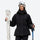 Women's belted snow jacket with suspender pants - black, front with upright skis and poles, for cold-weather winter sports