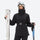 Women's waterproof 3L ski jacket and pants set - black, front with upright skis and poles, for resort and cross-country days