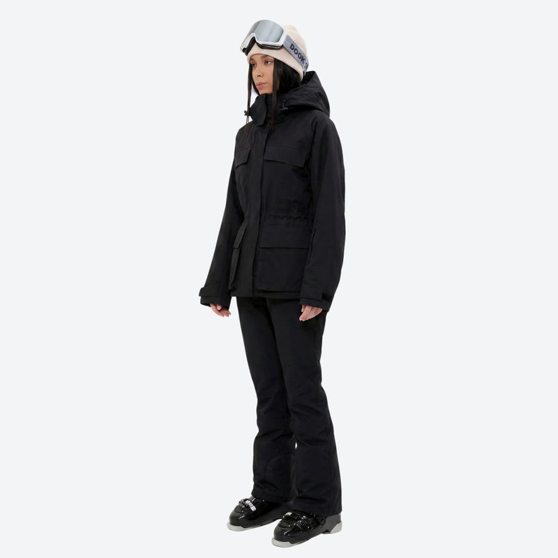 Women's waterproof 3L ski jacket and pants set - black jacket with black pants, on-model side view, for snowy mountain travel