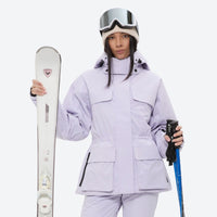 
                  
                    Women's waterproof 3L ski jacket and pants set - lavender, front with upright skis and poles, for cold-weather winter sports
                  
                