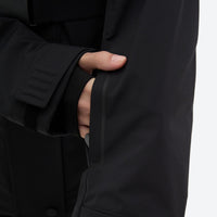 
                  
                    Women's waterproof 3L ski jacket and pants set - black, cuff close-up with hand, for snowy mountain travel
                  
                