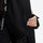 Women's belted snow jacket with suspender pants - black, chest zip close-up with hand, for resort and cross-country days