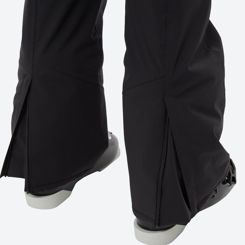 Women's breathable striped ski jacket with bibs - black, hem zip vent over boot close-up detail, for skiing and snowboarding
