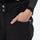 Women's 3-layer snowboard jacket and bib pants - black, waist pocket close-up with hand, for cold-weather winter sports