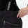 Women's 3-layer snowboard jacket and bib pants - black, waistband zip close-up with hand, for powder and piste riding