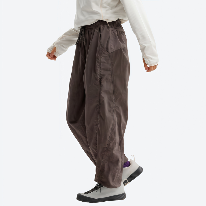 Unisex lightweight quick-dry hiking pants - brown hiking pants with white top, walking view, for daily outdoor wear