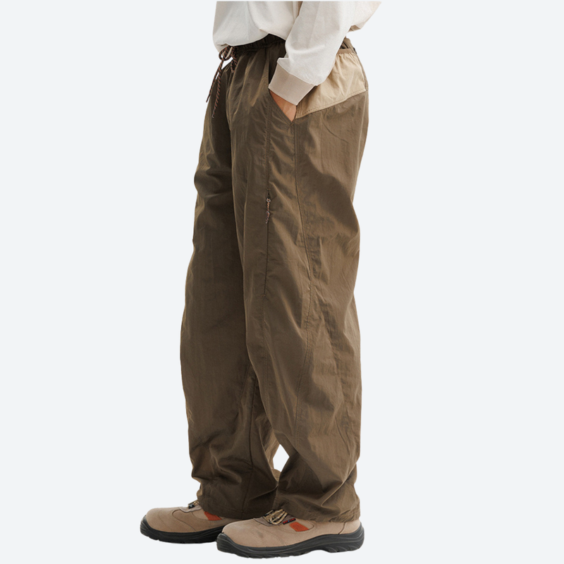 Breathable loose-fit trail pants with mesh lining - brown hiking pants, side view with hand in pocket, for daily outdoor wear