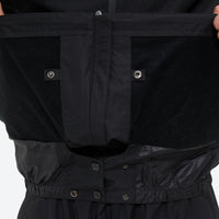
                  
                    Unisex snowboard jacket and pants with snow gaiters - black, inner snow skirt close-up detail, for cold-weather winter sports
                  
                