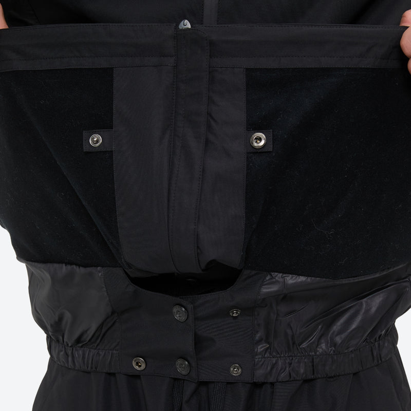 Unisex snowboard jacket and pants with snow gaiters - black, inner snow skirt close-up detail, for cold-weather winter sports