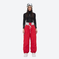 
                  
                    Unisex waterproof 2L snow jacket and pants - red snow pants with black top, on-model front view, for resort and street wear
                  
                