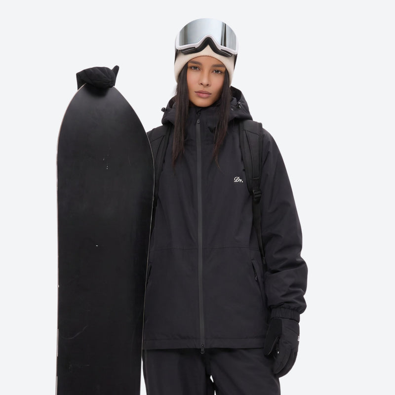 Unisex waterproof 2L snow jacket and pants - black jacket, on-model front with upright snowboard, for skiing and snowboarding