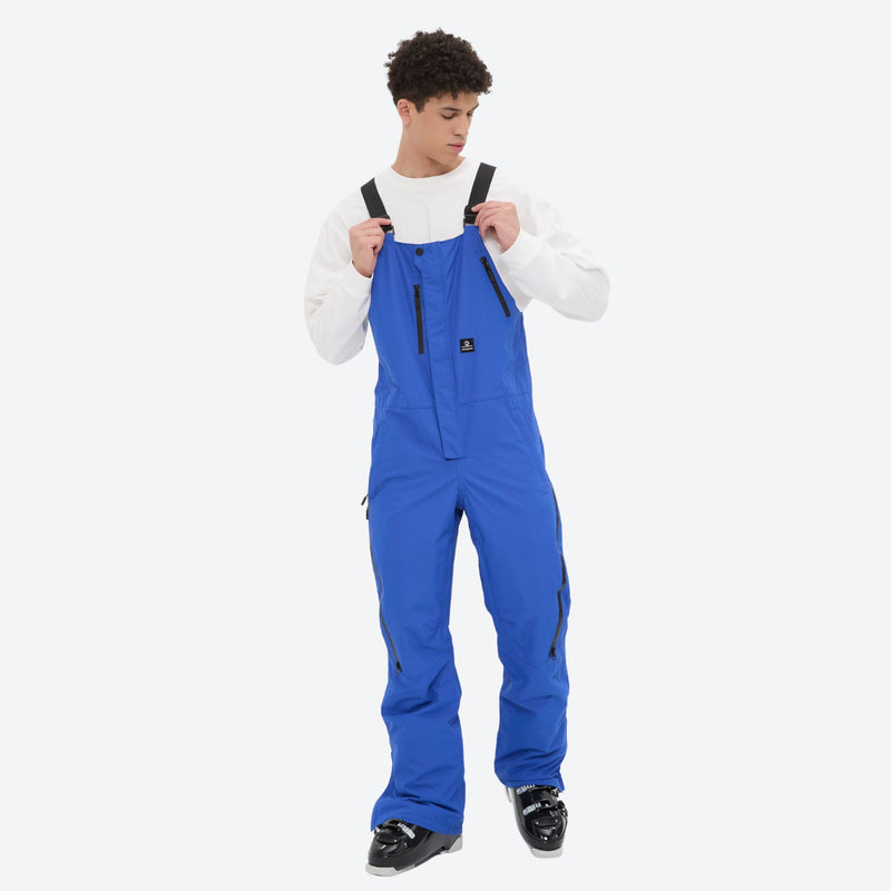 Men's waterproof 3L bib snow pants - blue bib snow pants, front view with hand at strap, for cold-weather winter sports