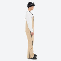 
                  
                    Men's breathable 3-layer suspender ski pants - tan bib snow pants with white top, for skiing and snowboarding
                  
                
