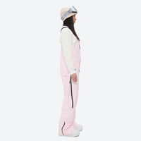 
                  
                    Women's minimalist bib snowboard pants with gaiters - pink bib snow pants with white top, for resort and backcountry days
                  
                
