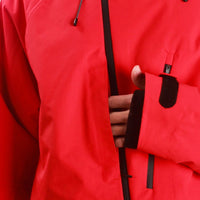 
                  
                    Men's waterproof 3L snow pants and jacket series - red, chest pocket close-up with hand, for powder days and winter commute
                  
                