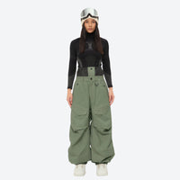 
                  
                    Women's waterproof 3L snow pants and jacket series - sage green snow pants with black top, for cold-weather winter sports
                  
                
