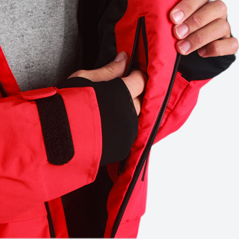 Women's breathable balloon snow pants set - red, interior lining close-up with hand, for powder days and winter commute