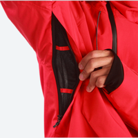 
                  
                    Men's 3-layer snowboard pants with jacket - red, underarm zip vent close-up with hand, for resort and street wear
                  
                