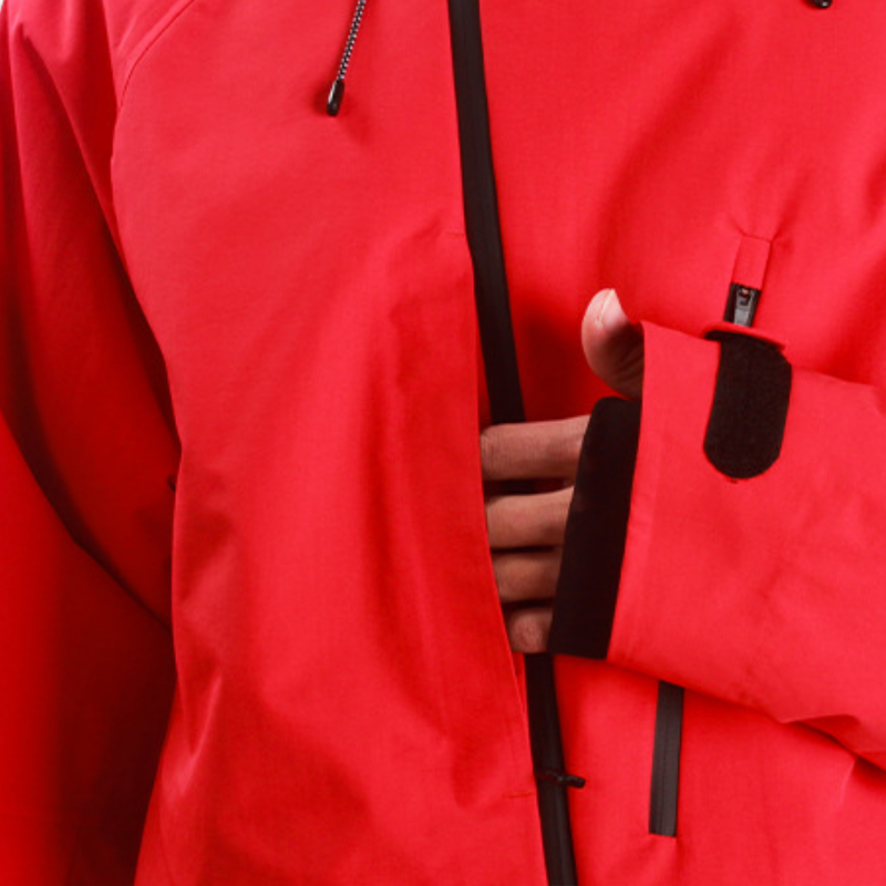 Women's 3-layer snowboard pants with jacket - red, chest zip close-up with hand, for skiing and snowboarding