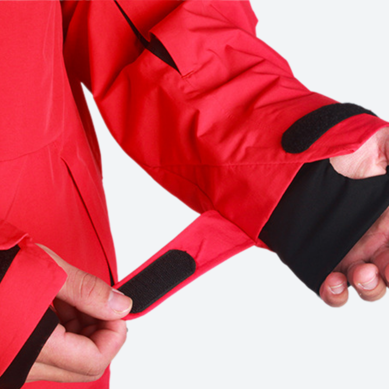 Women's breathable balloon snow pants set - red, cuff strap close-up with hand, for resort and street wear