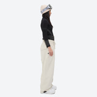 
                  
                    Women's waterproof 2L snow jacket and pants - cream snow pants, on-model side view, for resort and street wear
                  
                