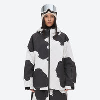
                  
                    Women's 2-layer snowboard jacket and pants - cow print, on-model full-body front view, for resort and street wear
                  
                