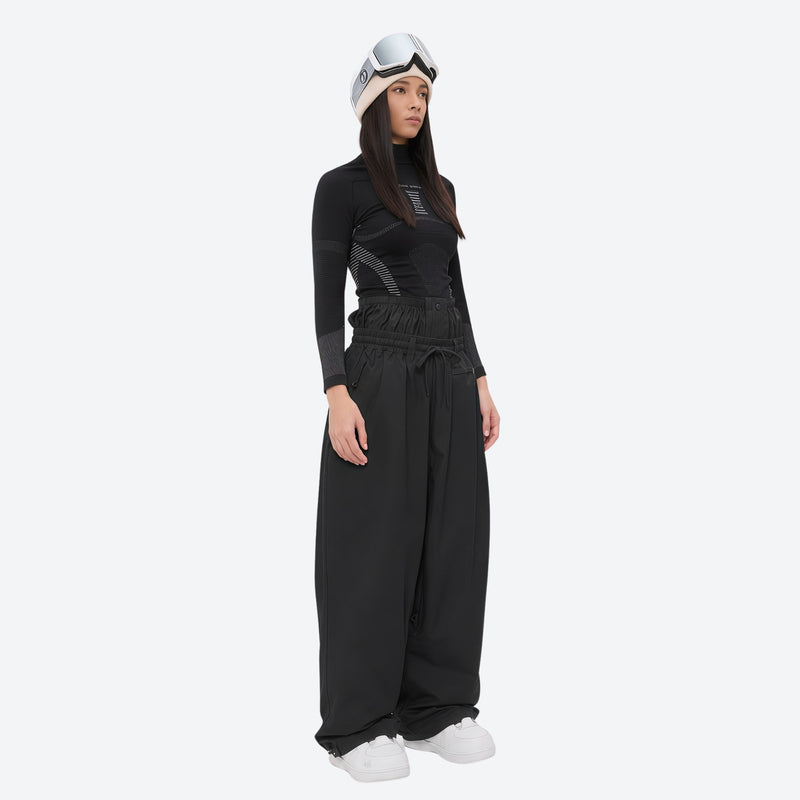Women's minimalist breathable ski jacket set - black snow pants, on-model side view, for powder days and winter commute
