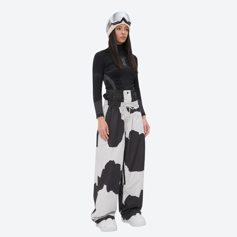 Women's minimalist breathable ski jacket set - cow print snow pants, on-model side view, for resort and street wear