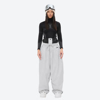 
                  
                    Women's minimalist breathable ski jacket set - white snow pants, on-model front view, for cold-weather winter sports
                  
                