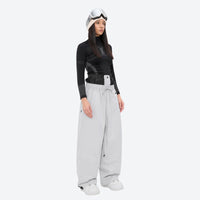 
                  
                    Women's 2-layer snowboard jacket and pants - white snow pants, on-model front view, for skiing and snowboarding
                  
                