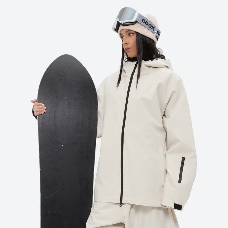 Women's waterproof 2L snow jacket and pants - cream, on-model front with upright snowboard, for cold-weather winter sports