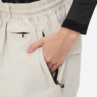 
                  
                    Women's colorblock ski jacket set - cream snow pants, side pocket close-up with hand, for powder days and winter commute
                  
                