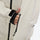 Women's minimalist breathable ski jacket set - cream, chest zip close-up with hand, for skiing and snowboarding
