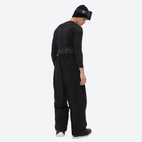 
                  
                    Men's 2-layer snowboard jacket and pants - black snow pants, on-model side view, for cold-weather winter sports
                  
                