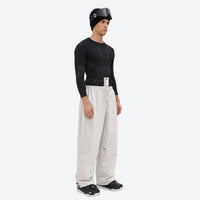 
                  
                    Men's 2-layer snowboard jacket and pants - cream snow pants, on-model side view, for cold-weather winter sports
                  
                