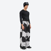 
                  
                    Men's 2-layer snowboard jacket and pants - cow print snow pants, on-model side view, for resort and street wear
                  
                