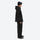 Men's 2-layer snowboard jacket and pants - black jacket with black pants, on-model side view, for cold-weather winter sports