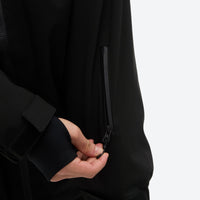 
                  
                    Men's 2-layer snowboard jacket and pants - black, chest zip close-up with hand, for resort and street wear
                  
                
