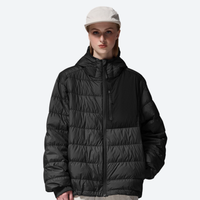 
                  
                    Women's insulated compact down jacket with color-block panel - black lightweight down hooded jacket on women with cap
                  
                