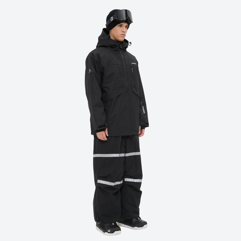 Unisex snowboard bib pants - black jacket with black bib pants, on-model side view, for cold-weather winter sports