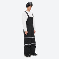 
                  
                    Unisex waterproof 3L bib snow pants - black bib pants with white top, on-model front view, for resort and street wear
                  
                