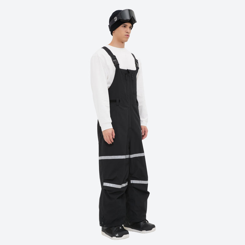 Unisex waterproof 3L bib snow pants - black bib pants with white top, on-model front view, for resort and street wear