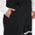 Unisex snowboard bib pants - black bib pants, side pocket close-up with hand, for cold-weather winter sports