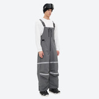 
                  
                    Breathable 3-layer suspender bibs with reflective trim - gray bib pants with white top, for cold-weather winter sports
                  
                