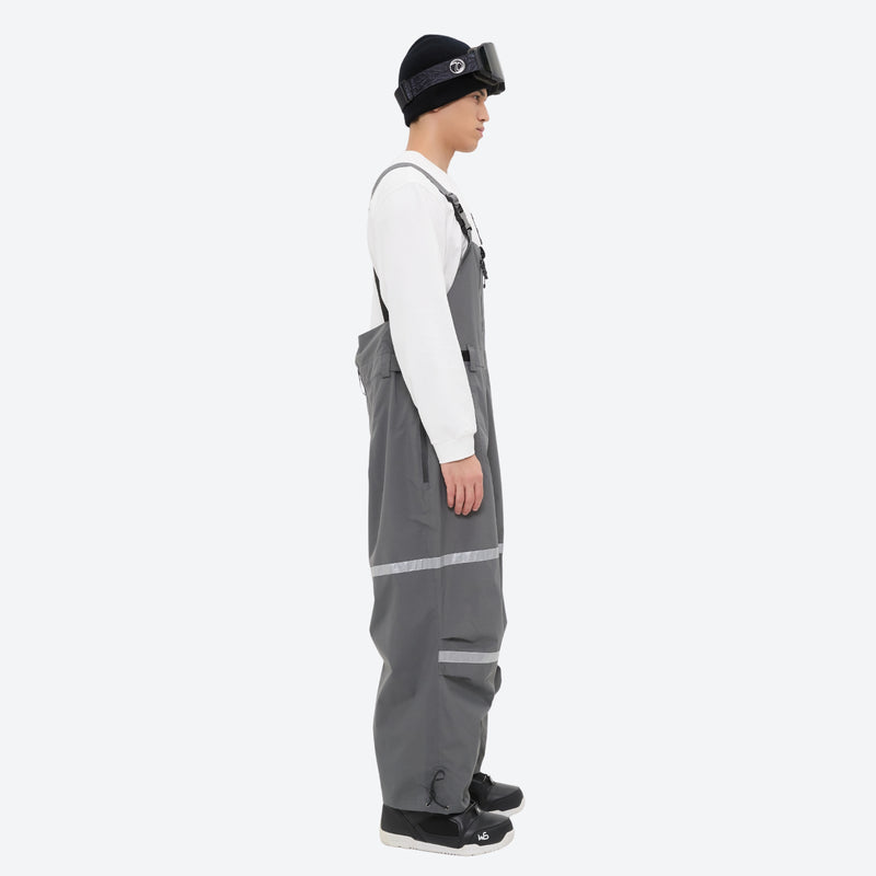 Unisex snowboard bib pants - gray bib pants with white top, on-model side view, for skiing and snowboarding
