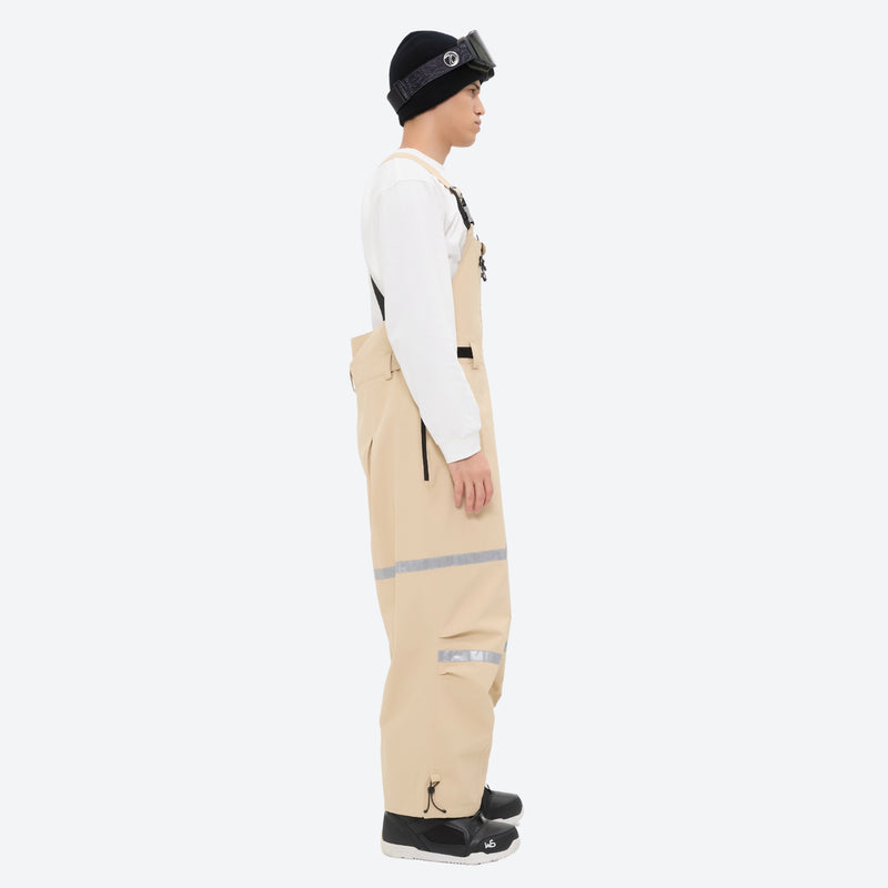 Unisex waterproof 3L bib snow pants - tan bib pants with white top, on-model side view, for skiing and snowboarding