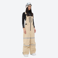 
                  
                    Women's 2-layer breathable snowboard jacket and bibs - tan bib pants, on-model front view, for skiing and snowboarding
                  
                