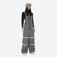 
                  
                    Women's reflective trim ski jacket with suspender bibs - gray bib pants, on-model front view, for resort and street wear
                  
                